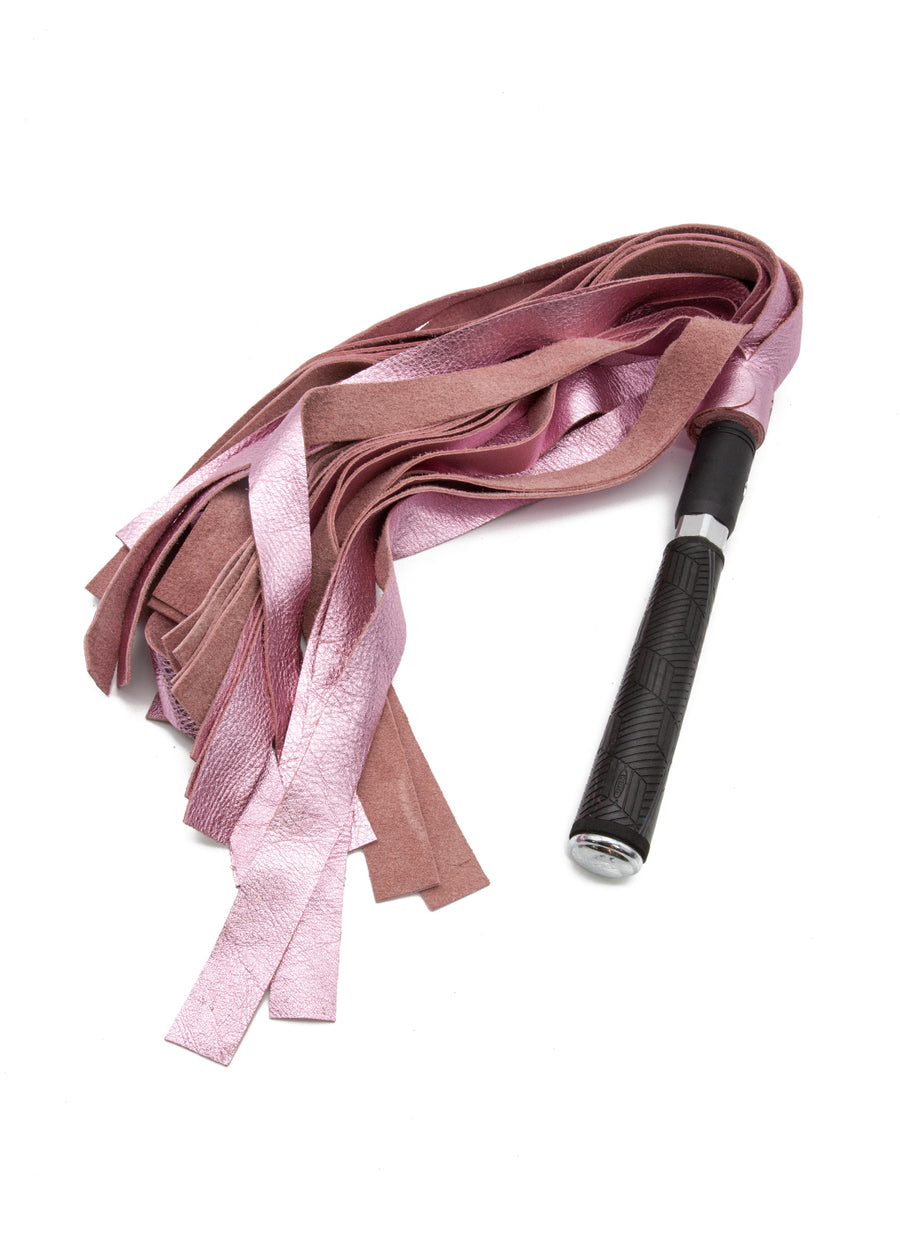 The Metallic Cow Leather Interchangeable Flogger Head 1" in Pink is shown attached to the Black Interchangeable Handle against a blank background.