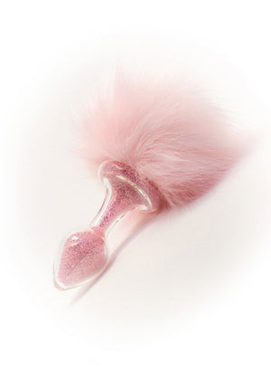 The Pink Magnetic Sparkle Bunny Tail Glass Butt Plug is shown against a blank background. The butt plug is filled with pink glitter, and a puff of pink fur is attached to the base of the plug.