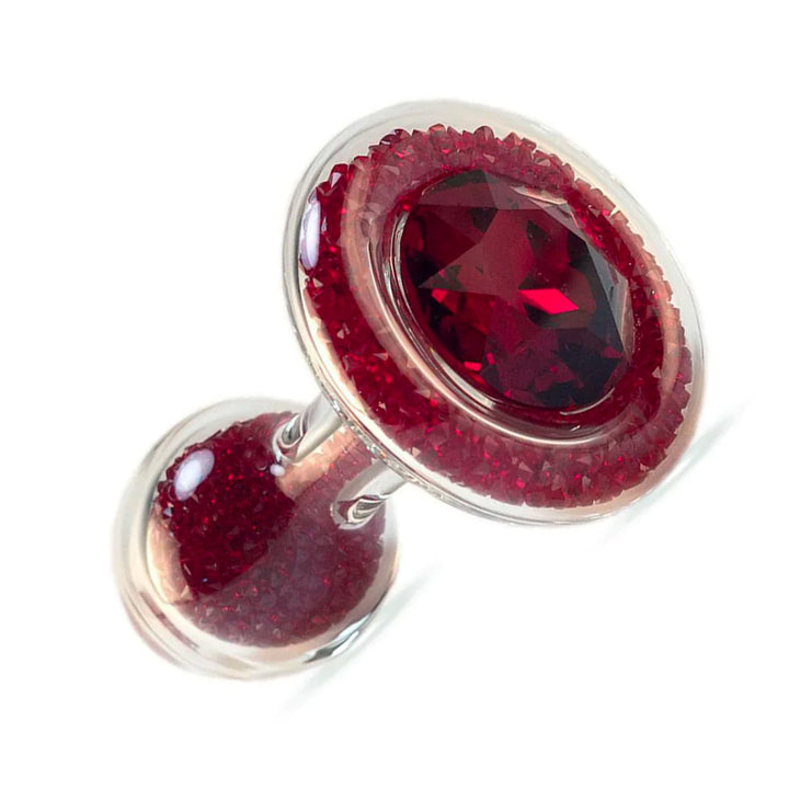 The Sparkle Glass Butt Plug With Crystal Base is shown in Red against a blank background. The plug is filled with red crystals and has one large, red crystal covering the base.
