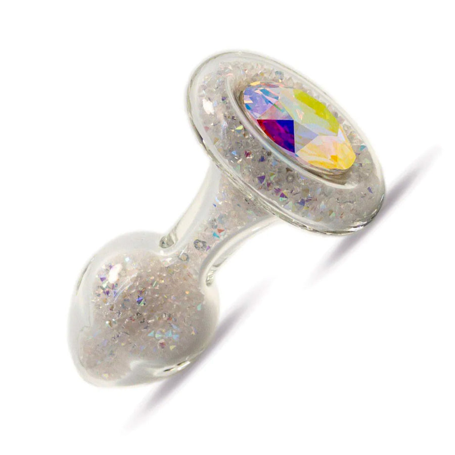 The Sparkle Glass Butt Plug With Crystal Base is shown in Aurora Borealis against a blank background. The plug is filled with clear, iridescent crystals and has one large, iridescent crystal covering the base.