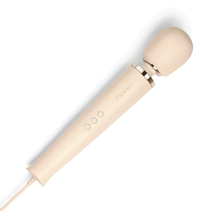 A Le Wand Plug-In Vibrating Massager in Cream is shown against a blank background. It has a long handle with 3 buttons, and a small, thin neck which is attached to the head of the vibrator.