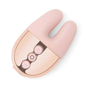 A Rose Gold Le Wand Chrome Double Vibe Rechargeable Vibrator is shown against a blank background. The base is curved with three buttons, and vibrator portion consists of two pink ears.