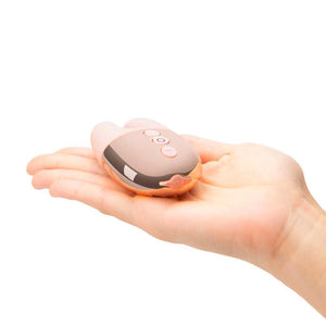 A Rose Gold Le Wand Chrome Double Vibe Rechargeable Vibrator rests on somebody’s palm against a blank background.