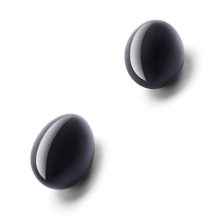 A pair of Le Wand Crystal Yoni Eggs made of Black Obsidian are displayed against a blank background.