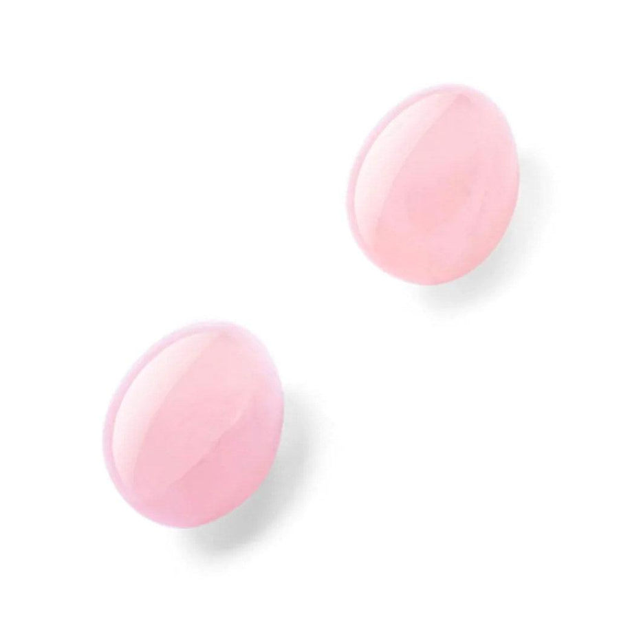 A pair of Le Wand Crystal Yoni Eggs made of Rose Quartz are displayed against a blank background.