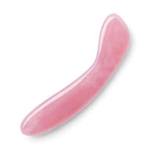 A Le Wand Crystal G Wand made of Rose Quartz is shown against a blank background. The toy has a slight upward curve at the top.