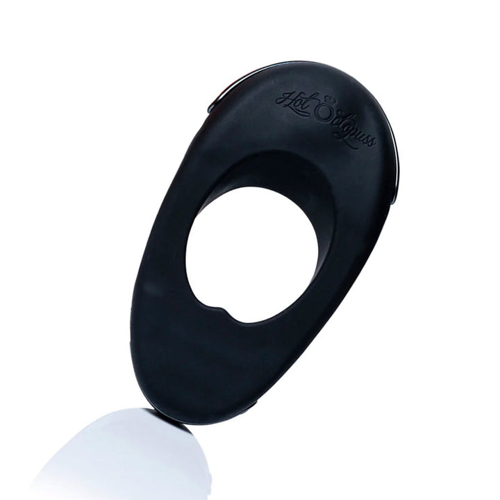 The Hot Octopuss Atom Plus Lux Vibrating Cock Ring is shown against a blank background. The toy is ovular with a circle cutout in the middle and is made of black silicone.