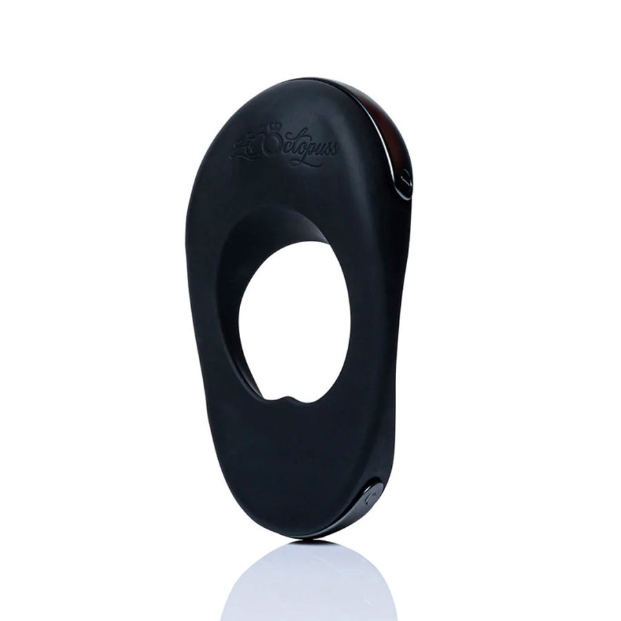 The Hot Octopuss Atom Plus Lux Vibrating Cock Ring is shown from the side against a blank background. There are thin metal bands on the top and bottom edges.