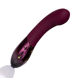 The Hot Octopuss Kurve G-Spot Vibrator is shown against a blank background. The toy is made of a matte silicone in a bordeaux color, with a matching plastic shimmering handle. The toy is curved with a slightly pronounced head.