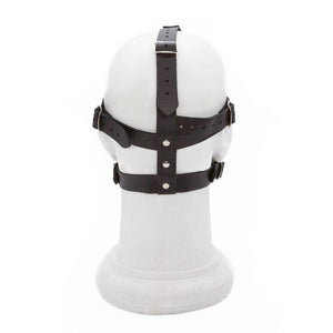 The Silicone Ball Gag And Blindfold Head Harness is shown on a mannequin head from the back. There are adjustable buckling straps on top of and around the head.