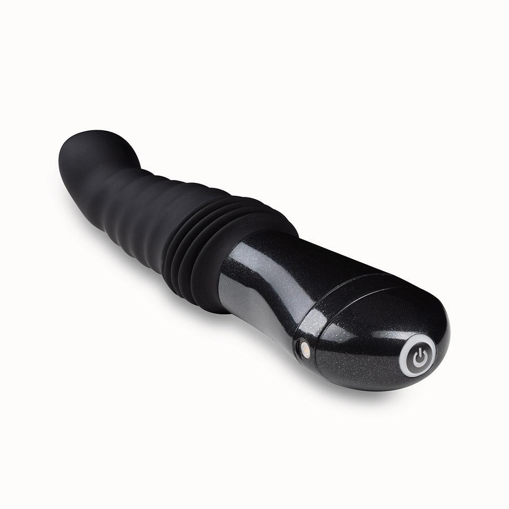 An image of the Temptasia Lazarus Thrusting Rechargeable Vibrating Dildo in Black by Blush Novelties on a plain white background.