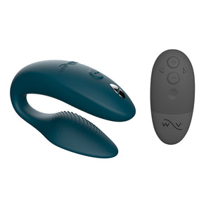 An image of the We-Vibe Sync 2 Couples Vibrator in the Green Velvet color on a plain white background. It is displayed next to the black remote control included.