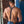 Load image into Gallery viewer, A shirtless, muscular man with brown hair stands beside a brick wall facing away from the camera. He is wearing blue jeans and the Deluxe Leather Suspenders. The suspender straps are Y-shaped and clip onto his belt loop.
