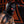 Load image into Gallery viewer, A man with tattoos and dark chest hair stands in front of a red wall with a black design on it. He is wearing the black Leather Bunny Hood.
