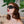 Load image into Gallery viewer, A close-up of a red-haired woman’s face is shown with a plant in the background. She has bright red lipstick on and is wearing the Vondage Polyfleece-Lined Blindfold.
