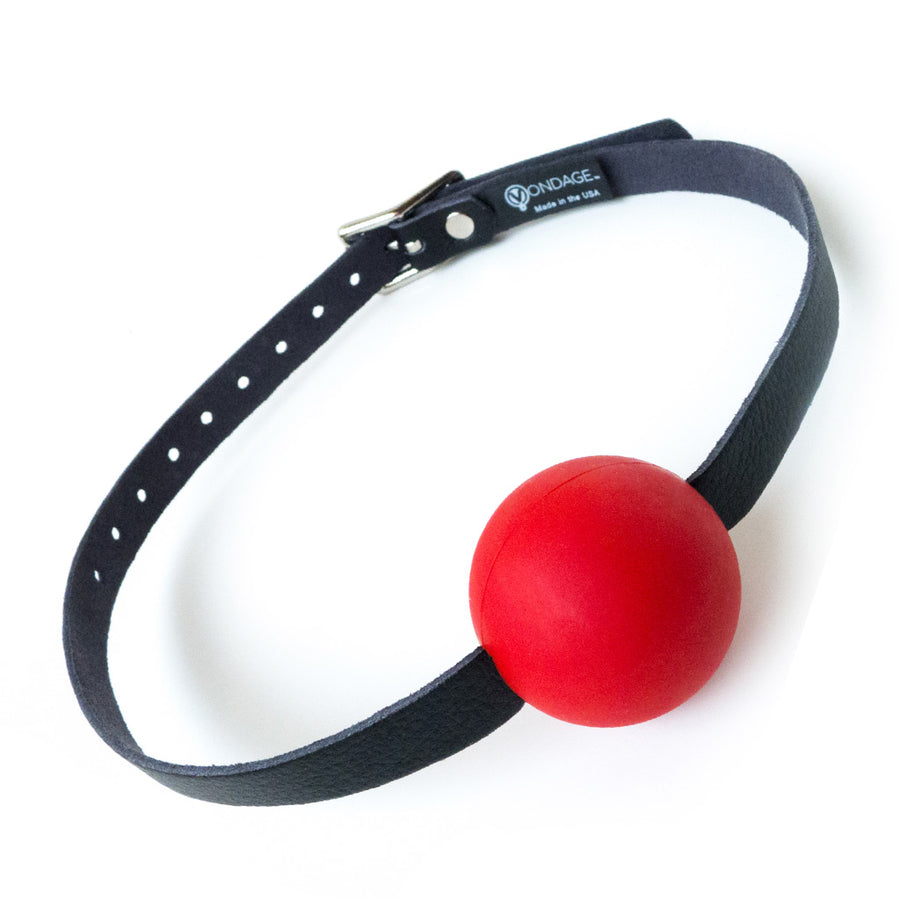 The Vondage Silicone Ball Gag is displayed against a blank background. The gag is bright red, and the black vegan leather strap is attached directly to it.