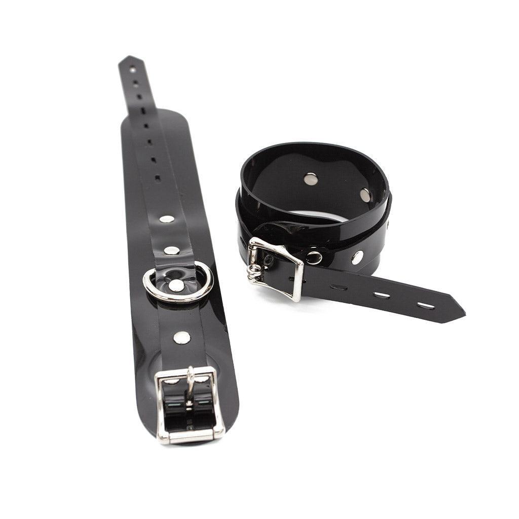 One buckled Stockroom Black PVC Ankle Cuff is shown next to one unbuckled ankle cuff against a blank background.