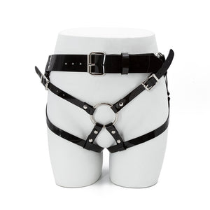 The Black PVC Strapon Harness made by The Stockroom is shown from the front displayed on the lower half of a mannequin.