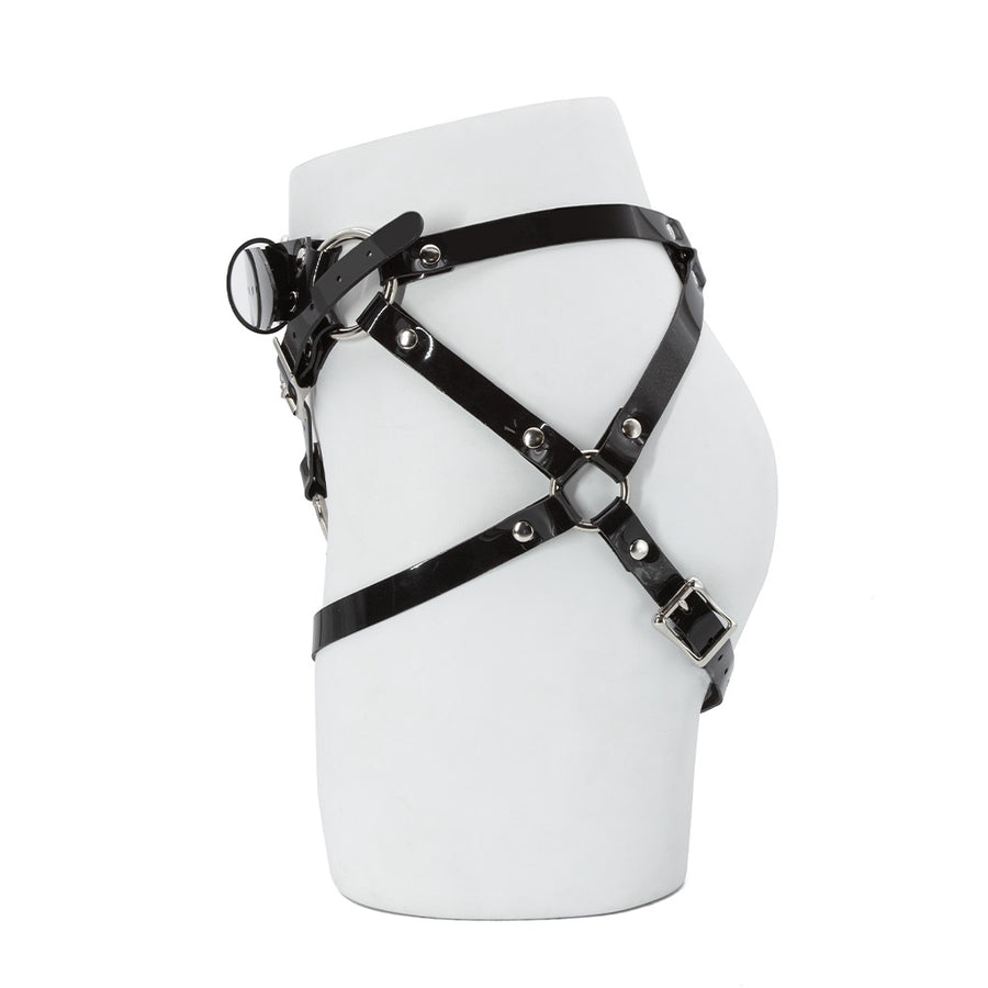 The Black PVC Strapon Harness made by The Stockroom is shown from the side displayed on the lower half of a mannequin.