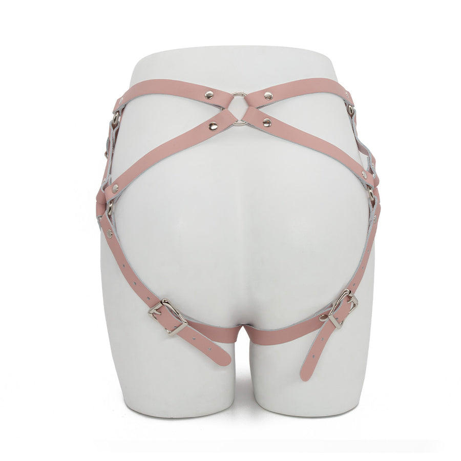 The pink leather Stockroom Stupid Cute harness is shown displayed on the lower half of a mannequin.