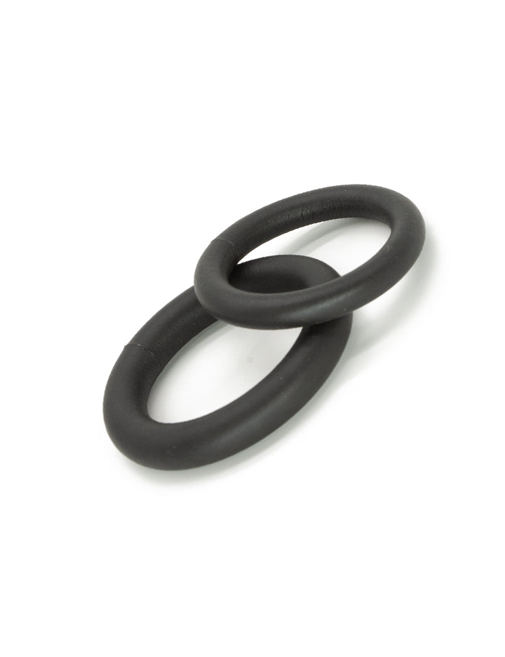 Two black cock rings from the Kinklab Neoprene Cock Ring Set are shown against a blank background.