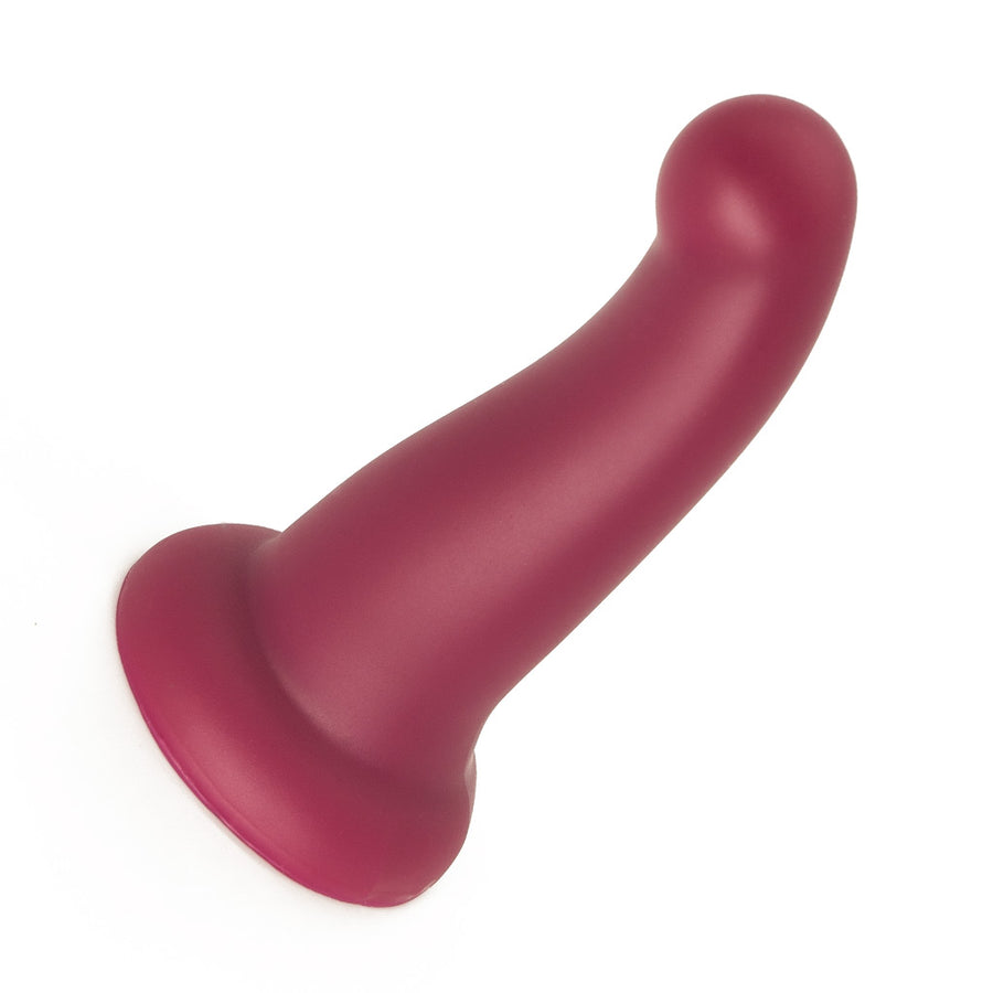 The KinkLab Ebb & Flow Silicone Dildo in Plum is shown against a blank background. The dildo is tapered and is curved at the top with a pronounced tip. The base of the toy is wide. 