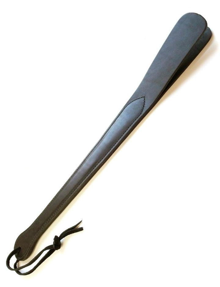 The black Leather Slapper for impact play is displayed against a blank background. It has a wrist loop at the bottom of the handle.