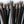 Load image into Gallery viewer, A close-up of the tips of the falls of the black leather 20-inch Thong Whip with Spiked Tails is displayed against a blank background.
