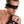 Load image into Gallery viewer, A shirtless brunette man is shown from the chest up in front of a blank background with his arms held in front of his chest. Black bondage tape binds his wrists together and covers his eyes.
