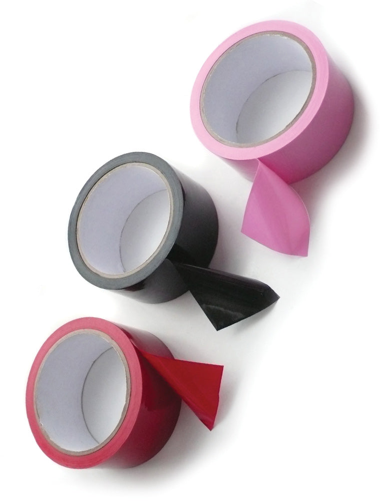 Three roles of Unpackaged Bondage Tape, one of each color, are displayed against a blank background. The roll of tape on the left is red, the one in the middle is black, and the one on the right is pink.