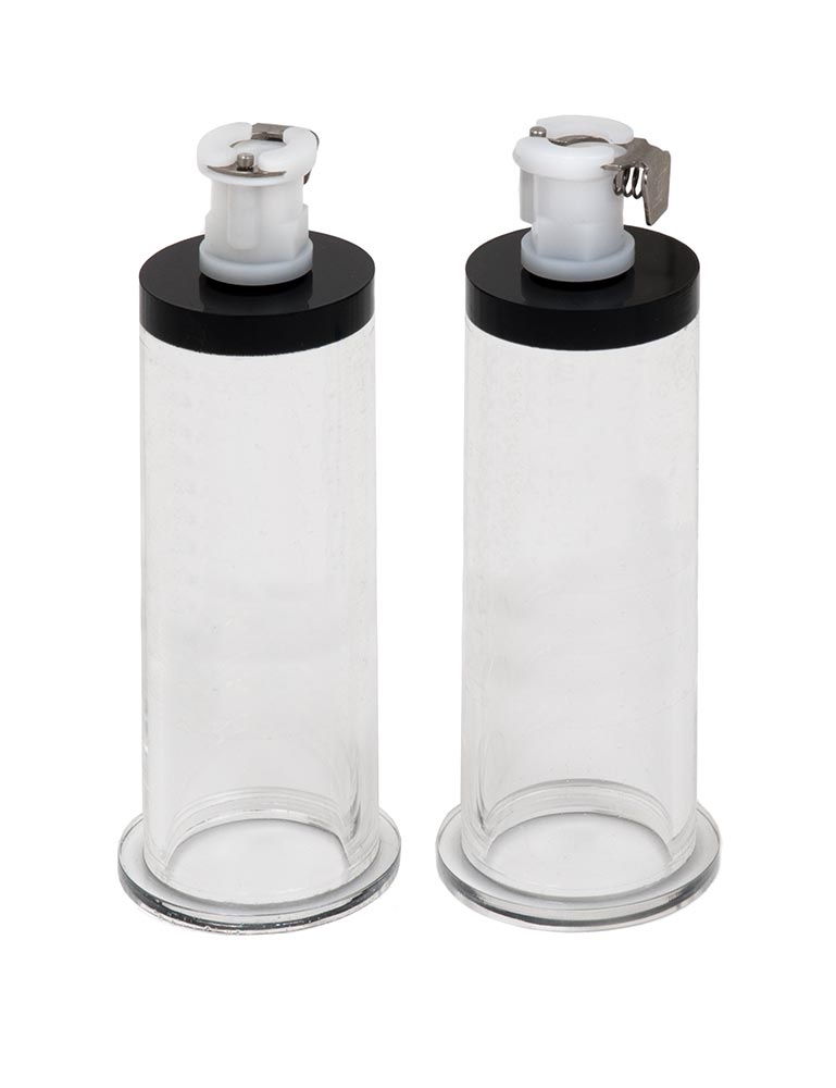 A pair of Nipple Suction Cylinders are displayed against a blank background. They are transparent plastic cylinders with flared bases and small attachment points at the tops for a suction pump.