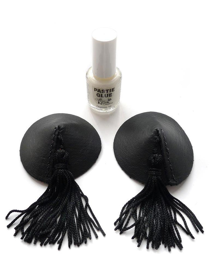 The Black Leather Pasties with black tassels are displayed against a blank background alongside a bottle of pastie glue.