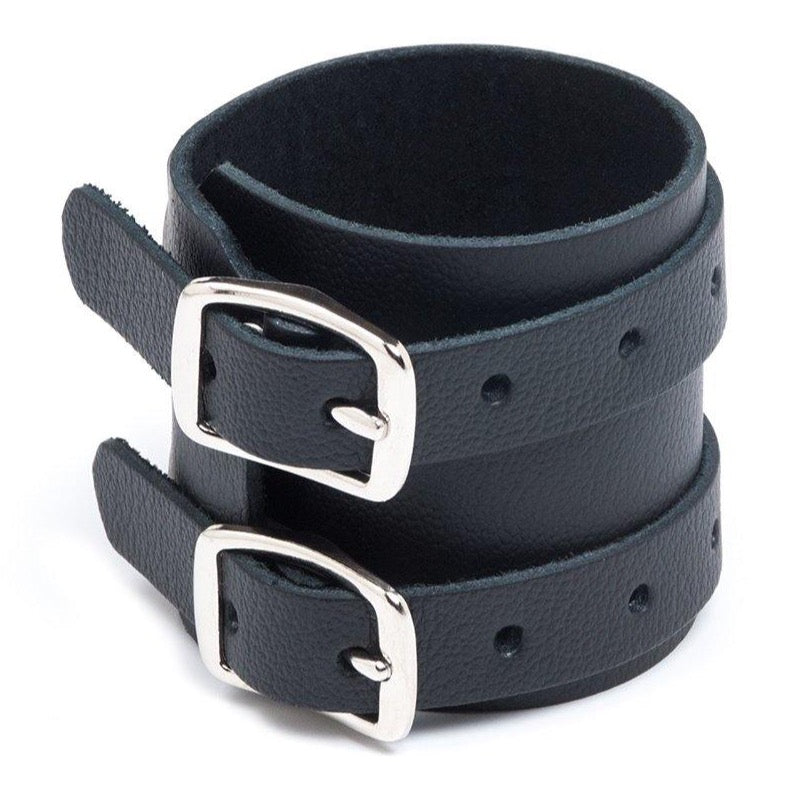 The 2-Strap Black Leather Wrist Band is displayed against a blank background. It is a black leather cuff with two adjustable straps with silver metal buckle closures.