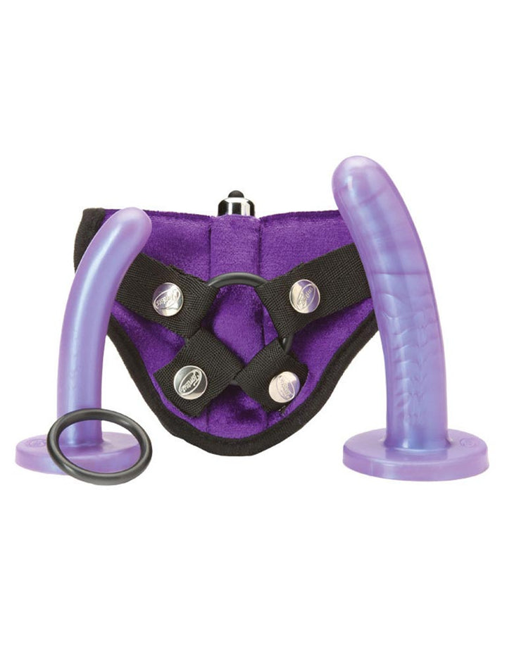 The Tantus Bend Over Harness Kit is shown against a blank background. It has a strap-on made of purple fabric with a pocket for a bullet vibrator, two slightly curved light purple dildos, one smaller than the other, and an extra silicone O-Ring. 