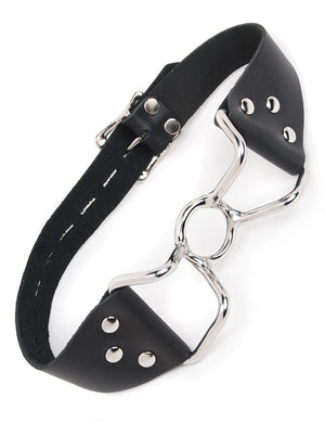 The Spider Gag is shown against a blank background. It is made of a silver metal O-ring in the center with protruding metal handles on each side. A black leather strap connects to the gag's handles. 