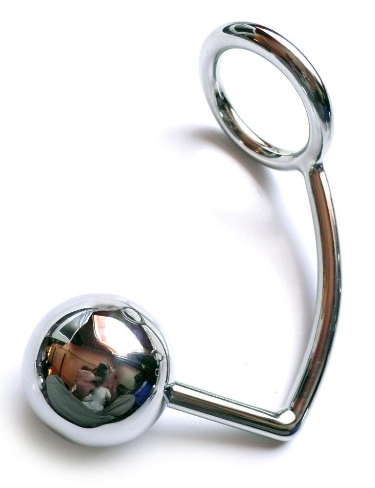 The silver stainless steel Trailer Hitch is displayed against a blank background. A hooked piece of steel has an anal plug ball on one end and a cock ring on the other.