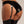Load image into Gallery viewer, A close-up of a woman&#39;s butt is shown against a grey background. She wears a full set of black latex lingerie, including panties, stockings, and the Mila Garter Belt from Syren Latex.
