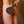 Load image into Gallery viewer, A nude woman is shown from the shoulders down, facing the wall, with somebody holding the Ebony Pine Peony Engraved Wooden Spanking Paddle against her butt.
