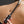 Load image into Gallery viewer, A close-up of a woman’s bare stomach is shown against a grey background. She has a French manicure and holds the Electrastim Depth Charge Electro Dildo on her stomach.
