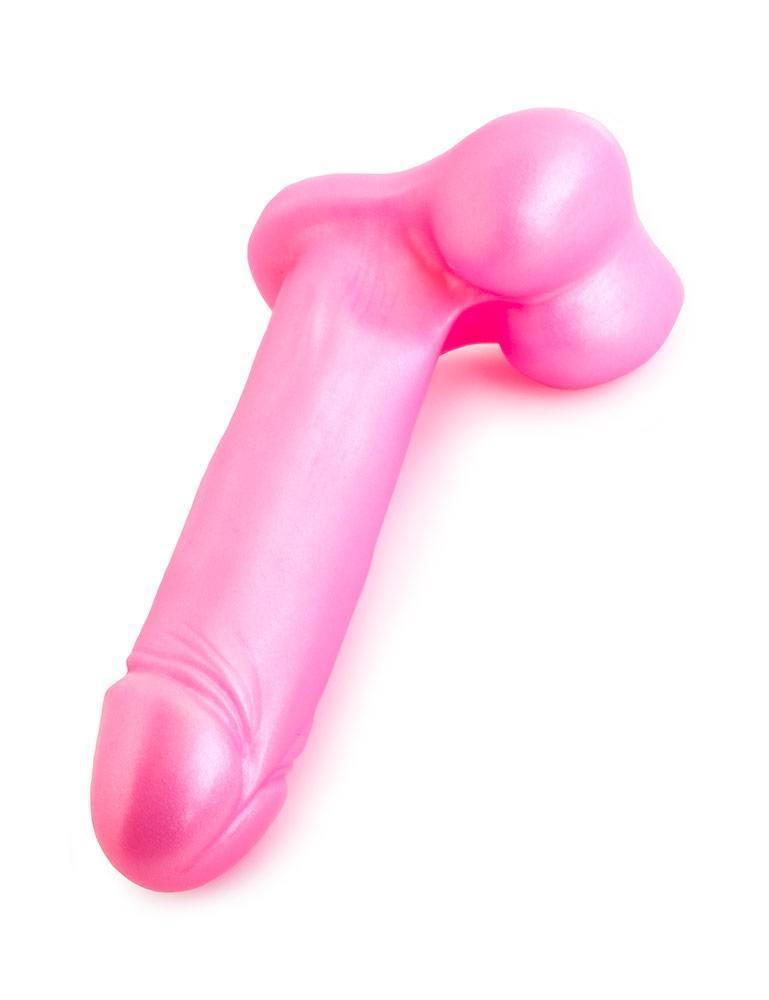The Tantus Champion Dildo lying on a white surface, the tip pointed at the viewer. 
