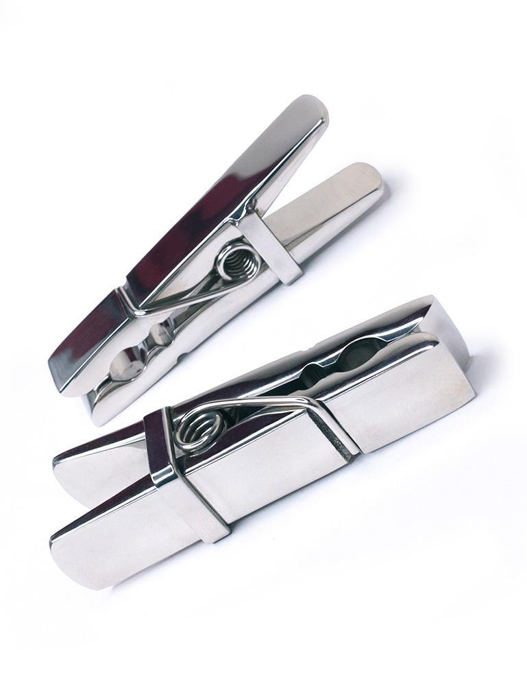 The Stainless Steel Clothespin Nipple Clamps are shown against a blank background. They look exactly like clothespins, but are entirely made of shined stainless steel.