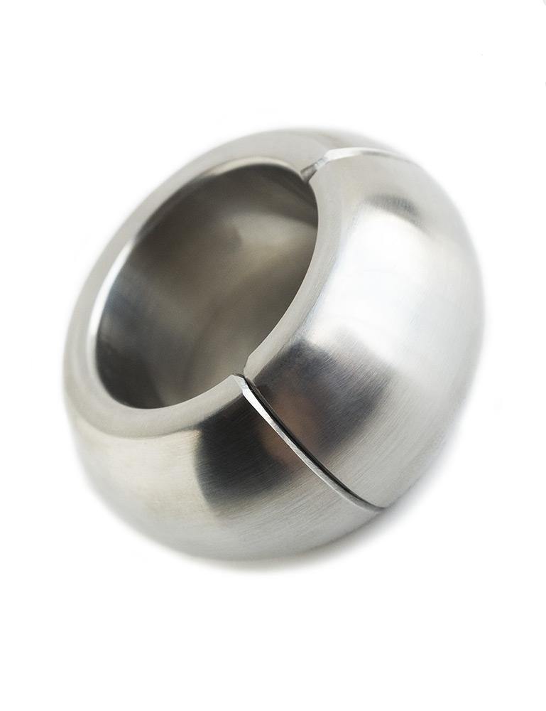 The Ze Mango Magnetic Ball Stretcher is displayed against a blank background. It is a silver metal ring that resembles a donut. 