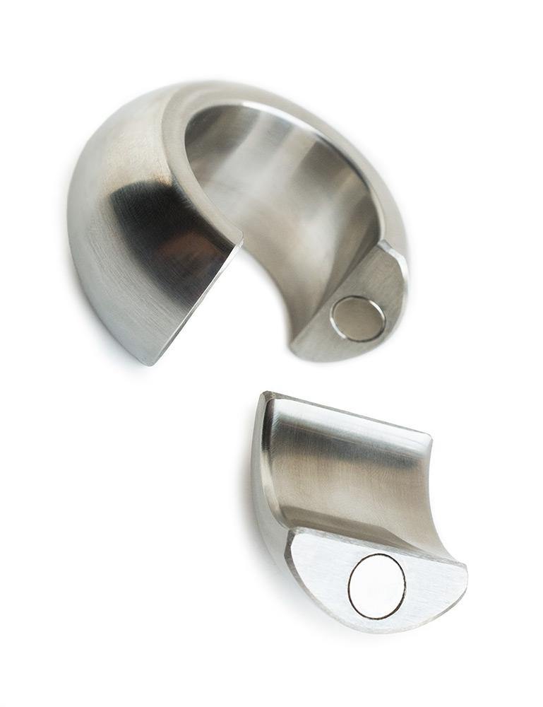 The Ze Mango Magnetic Ball Stretcher is shown disassembled against a blank background. The ring has a small piece that can be removed and attached back on magnetically. The small piece is shown next to the ball stretcher.