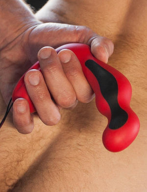  A close-up of a naked man’s lower back and ass is shown. He holds the Electrastim Silicone Fusion Habanero Prostate Massager behind his back.