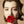 Load image into Gallery viewer, A close-up photo of a brunette woman with the Rose Ball Gag in her mouth in front of a beige backdrop. 
