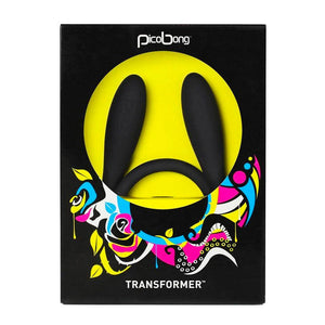 A Picobong Transformer Silicone Vibrator in black is shown in its packaging, which is a black box with a transparent cut out showing the toy. There is a neon flower design beneath the cutout.