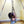 Load image into Gallery viewer, A woman is shown suspended from the Tetruss Maxximus Suspension Bondage Frame. She is suspended by her leg, which is tied in a bent position. Her brown hair hands down as she lowers her head.
