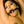 Load image into Gallery viewer, A close-up of a topless brunette woman is shown. Her arms are raised above her head, and she has the black O-Ring Gag in her mouth.

