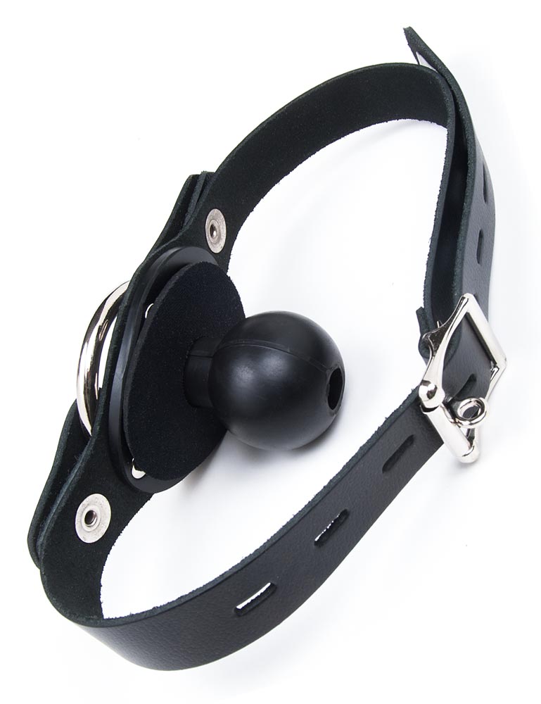 The Locking Ball Gag with a Dildo Ring is shown from behind against a blank background. The gag is a black rubber ball with a small hole attached to a black plate. The leather strap is adjustable and closes with a lockable metal buckle.