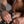 Load image into Gallery viewer, A close-up of a man&#39;s thigh is shown. He is putting on the black Leather Thigh Dildo Strap with a brown dildo attached.
